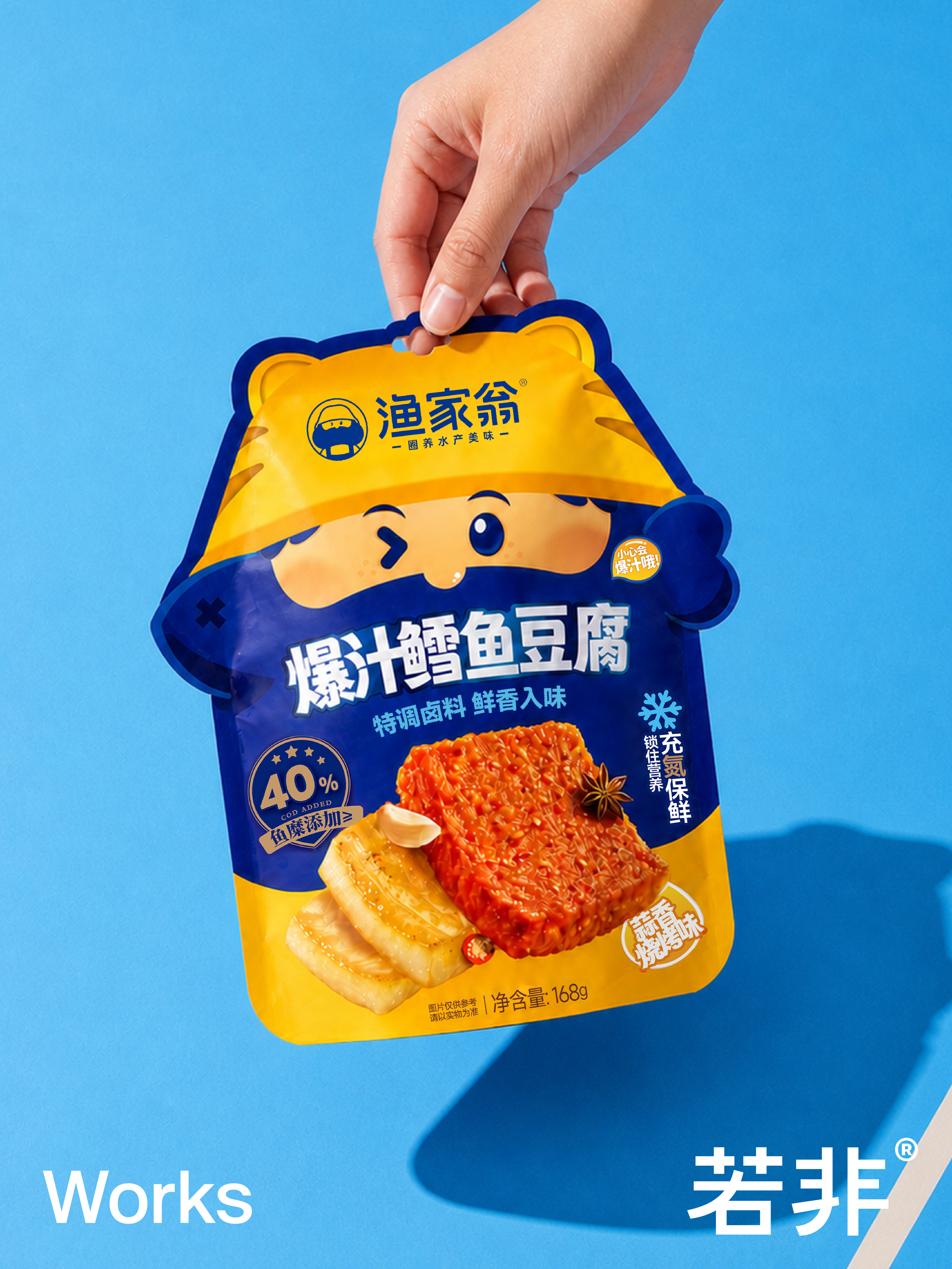 蓝色背景中手提展示的渔家翁爆汁鳕鱼豆腐异形包装